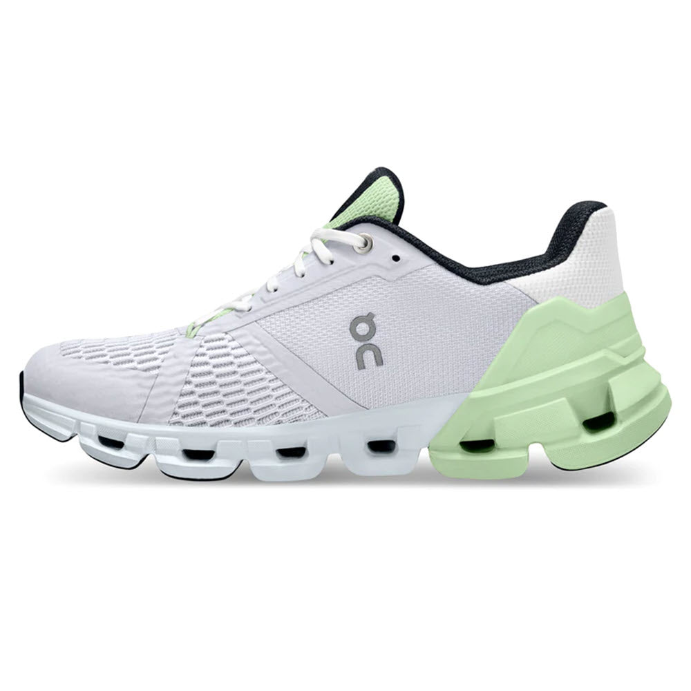 A pair of white ON Running Cloudflyer running shoes with a green sole and lace accents.