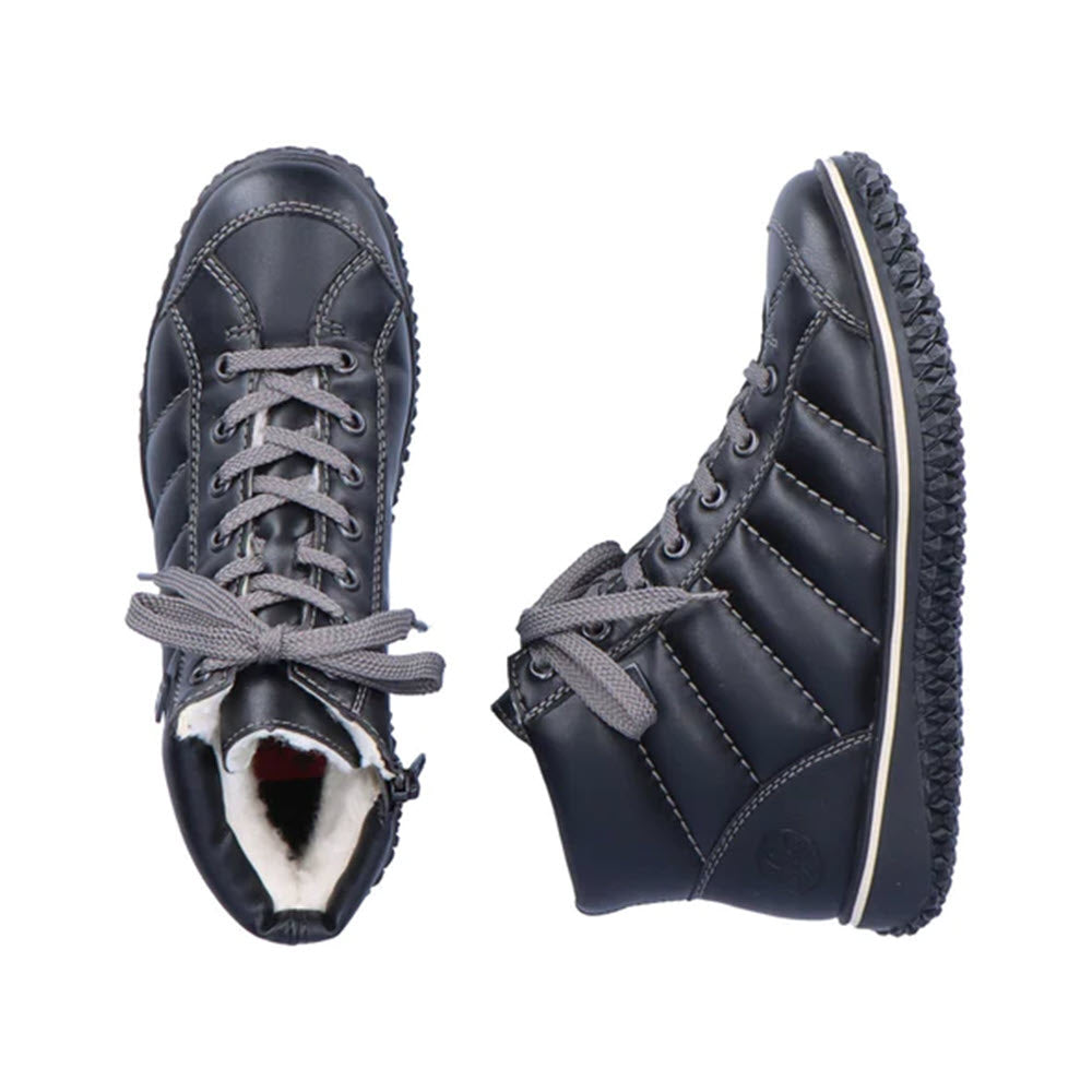 A pair of black, quilted Rieker Puff High Top winter boots with laces on a white background, designed for comfort.