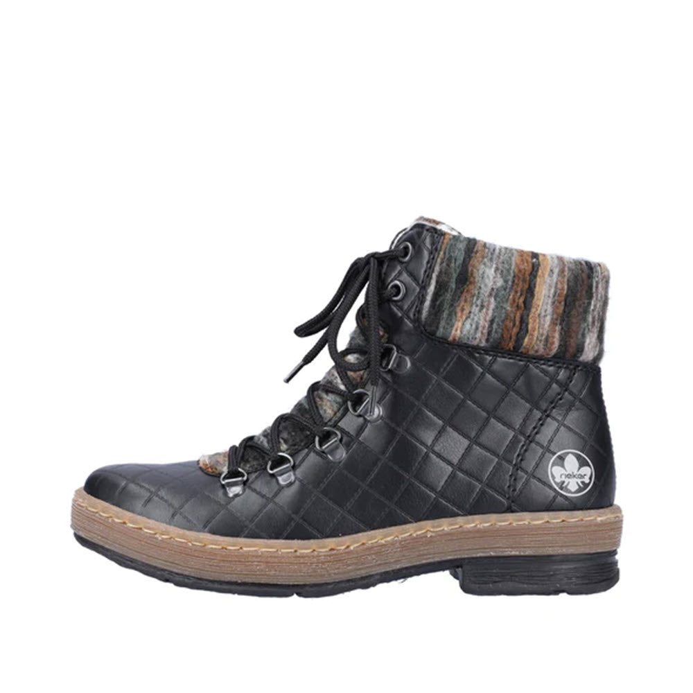 A black, quilted winter ankle boot with a patterned fabric cuff and lace-up front, featuring a small floral emblem on the side is the RIEKER YARN CUFF LACE UP BOOTIE BLACK by Rieker.
