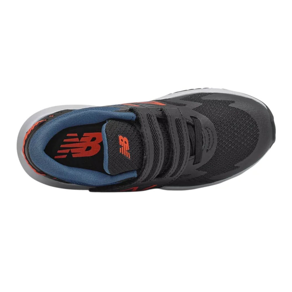 Top view of a black New Balance Rave Run Hook &amp; Loop kids&#39; running shoe with red accents.