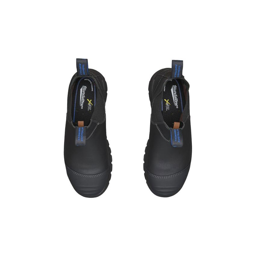 A pair of Blundstone 990 Steel Toe Black - Mens boots with blue pull tabs against a white background.