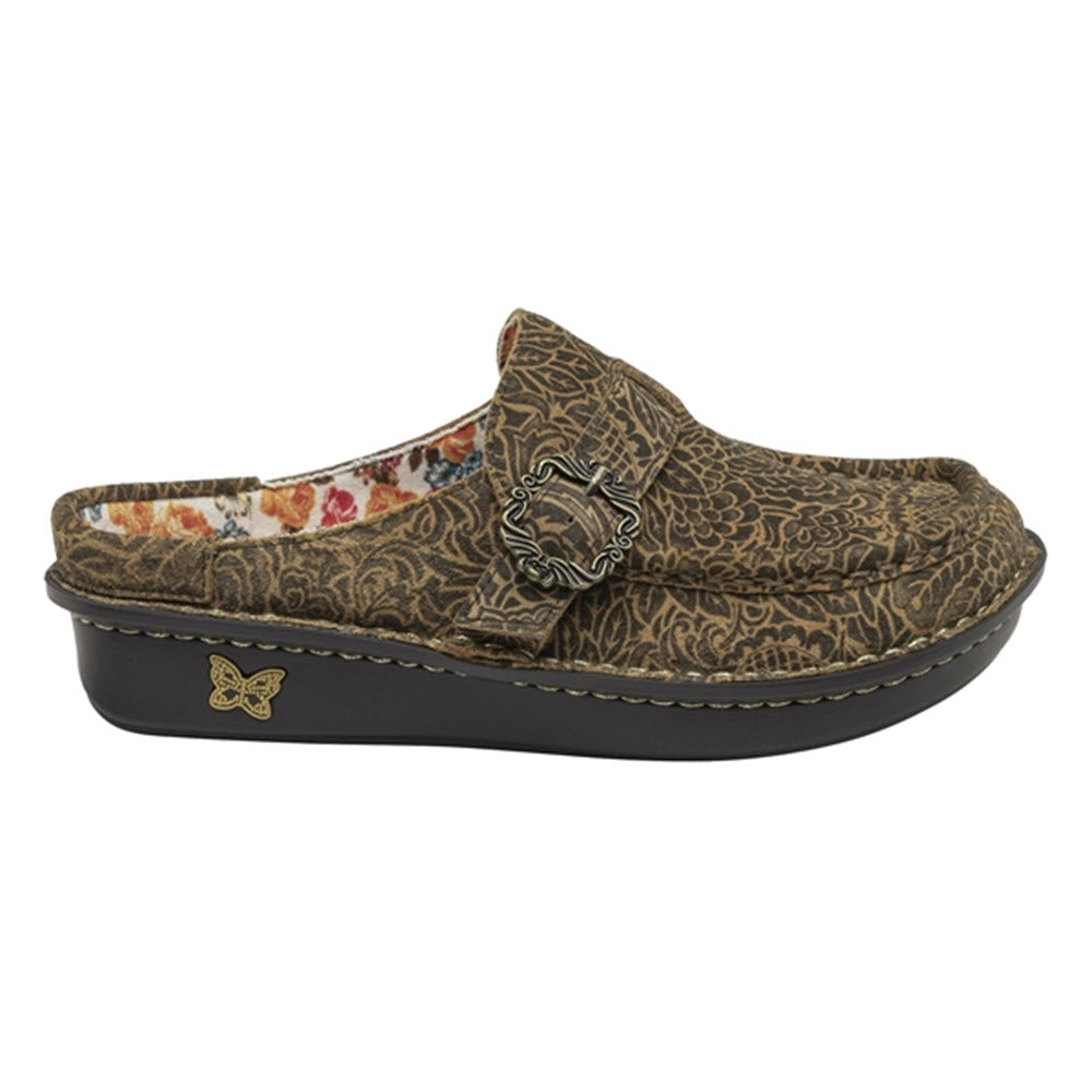 Patterned brown clog with a decorative metal buckle on top and a slip-resistant outsole, isolated on a white background - ALEGRIA BRIGID FREEDOM ROCK - WOMENS by Alegria.