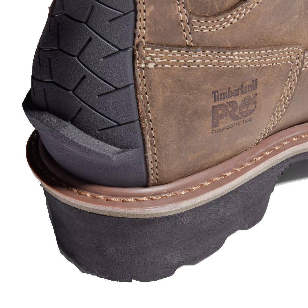 Close-up of the heel of a Timberland Evergreen NT Insulated Logger coffee work boot featuring a rugged, treaded sole, embossed branding, and composite safety-toe.