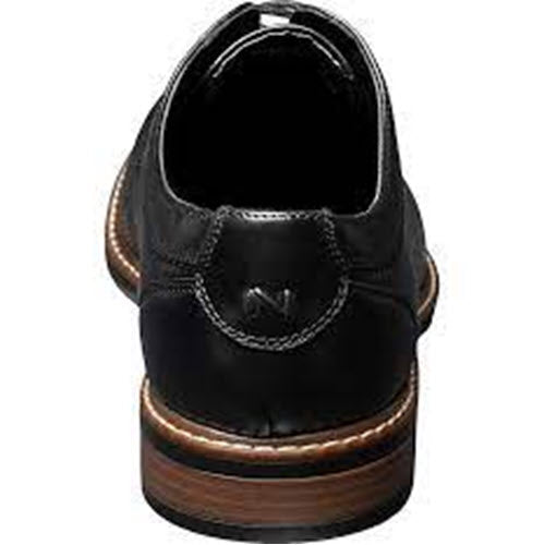 Black leather Nunn Bush Hayden Plain Toe Oxford with a wooden heel, embodying classic elegance.