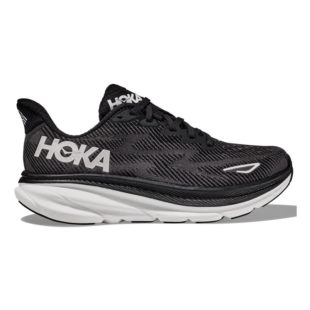 Sentence with replaced product: Black and white Hoka Clifton 9 running shoe with a prominent Hoka logo on the side, designed with a thick white sole and an improved outsole design.