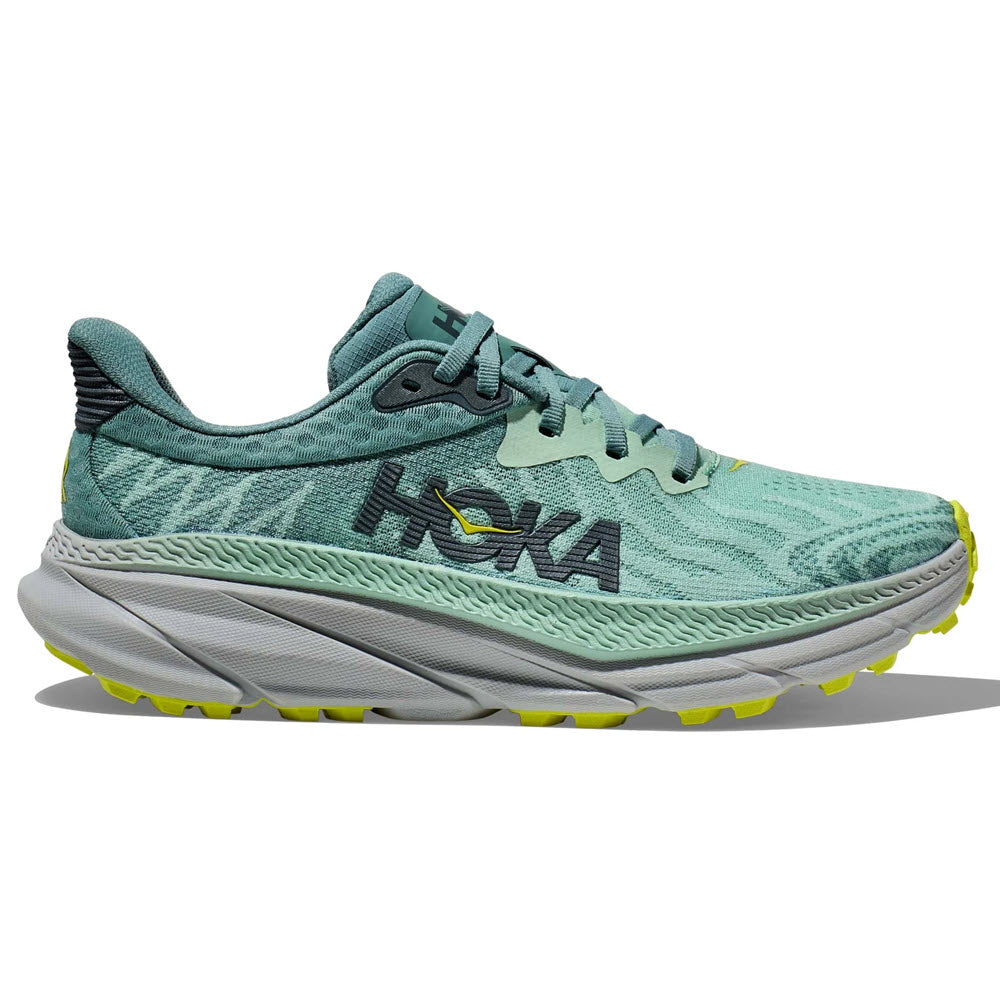 Mist green HOKA Challenger ATR 7 running shoe with trellis accents and a vibrant yellow detail on the sole, designed for an all-terrain plush experience.