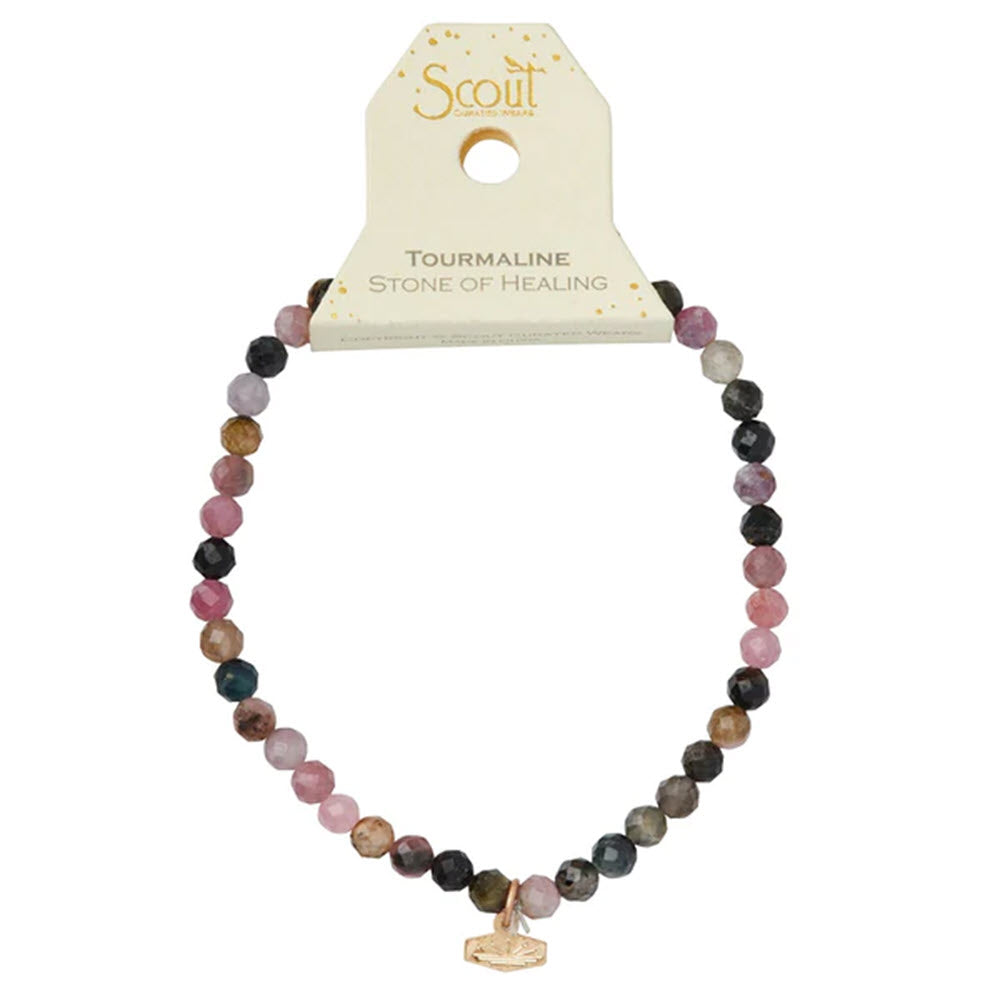 Beaded tourmaline bracelet with a Scout logo charm, marketed as a &quot;stone of healing&quot; is the SCOUT MINI FACETED BRACELET TOURMALINE/GOLD by Scout.