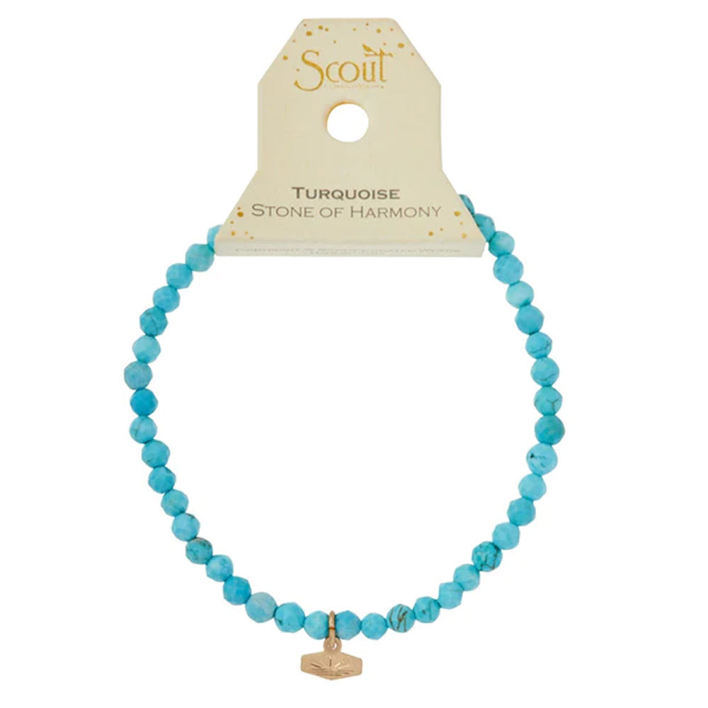 Turquoise bead stackable jewelry with a gold charm on a display card labeled &quot;Scout mini faceted bracelet turquoise/gold&quot;.