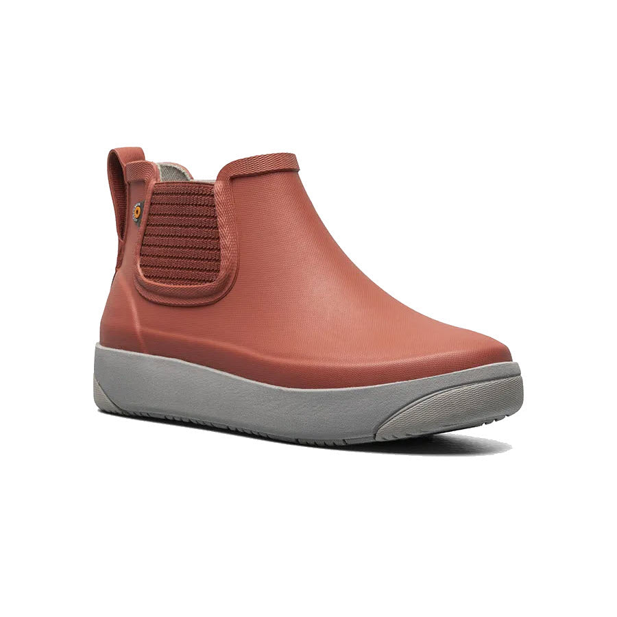 A coral pink Bogs Kicker Rain Chelsea II Ember boot with a grey sole and elastic side panel, displayed against a white background.