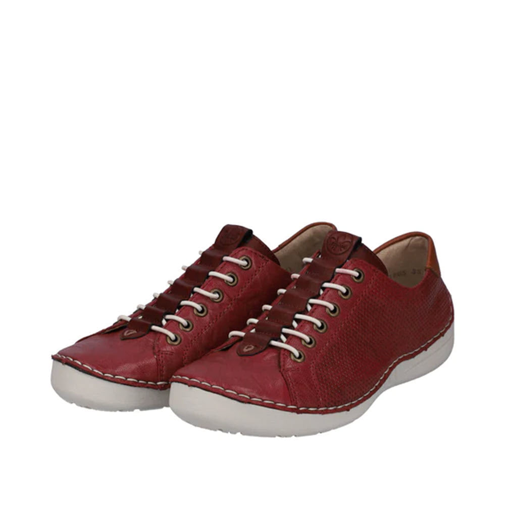 A pair of Rieker wine red leather sneakers with white soles and lace-up fronts, displayed on a plain white background.