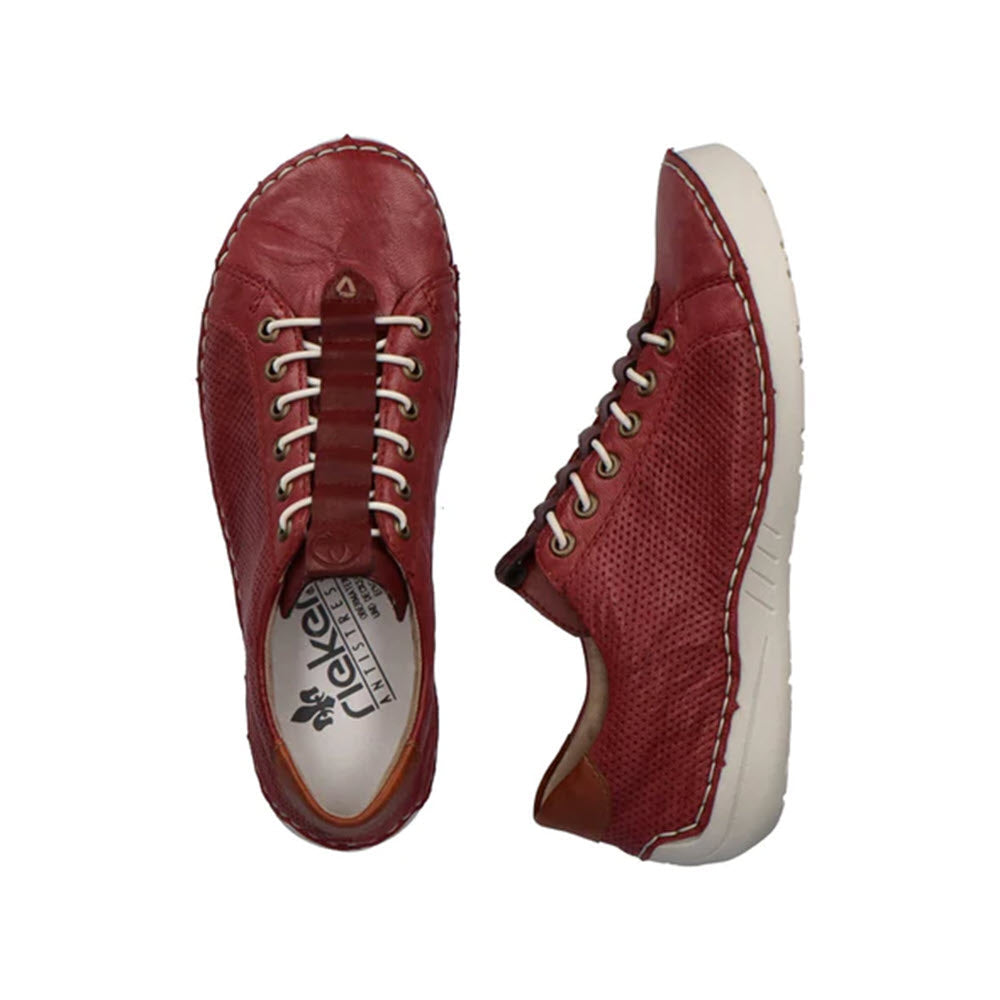 A pair of Rieker wine red leather sneakers with white soles and laces, displayed with the top view of one and the side view of the other.
