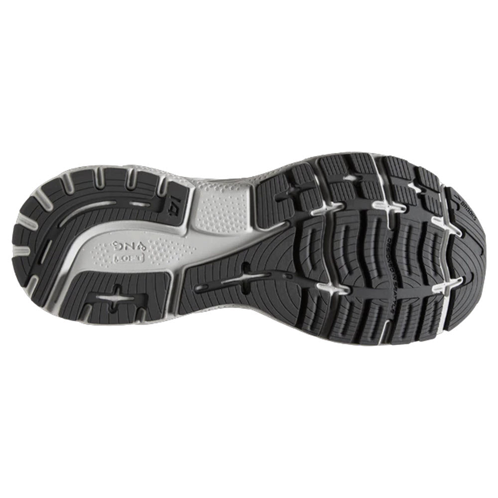 Tread pattern of a Brooks Ghost 14 Alloy/Primer Grey/Oyster - Women&#39;s running shoe sole with black and white rubber material.