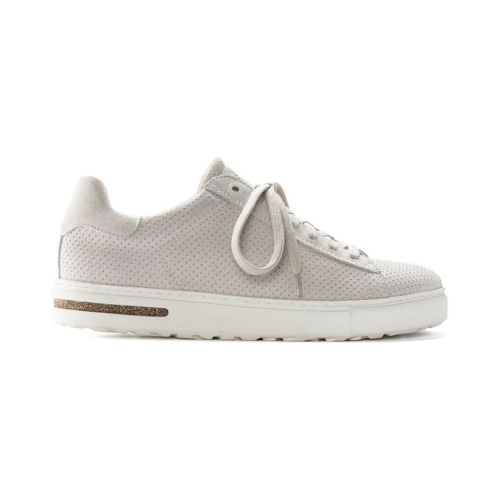 A light gray casual sneaker with a perforated upper, white laces, and a white rubber sole featuring a contoured cork footbed visible in the midsole, displayed against a white background.