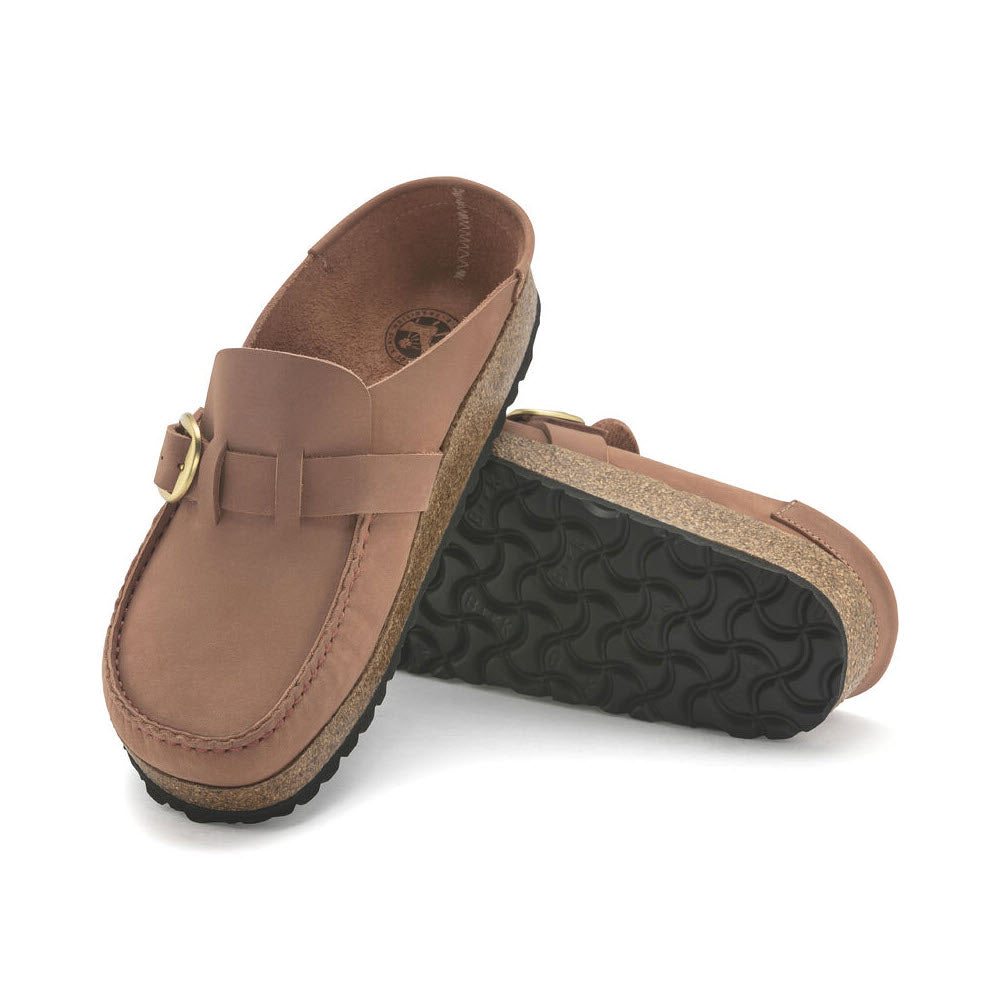 A pair of brown BIRKENSTOCK BUCKLEY OLD ROSE NUBUCK clogs with buckle detail and black soles, displayed on a white background.