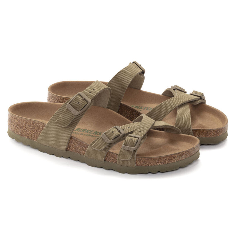 A pair of faded khaki Birkenstock Franca Vegan canvas sandals with adjustable straps and a vegan footbed, isolated on a white background.