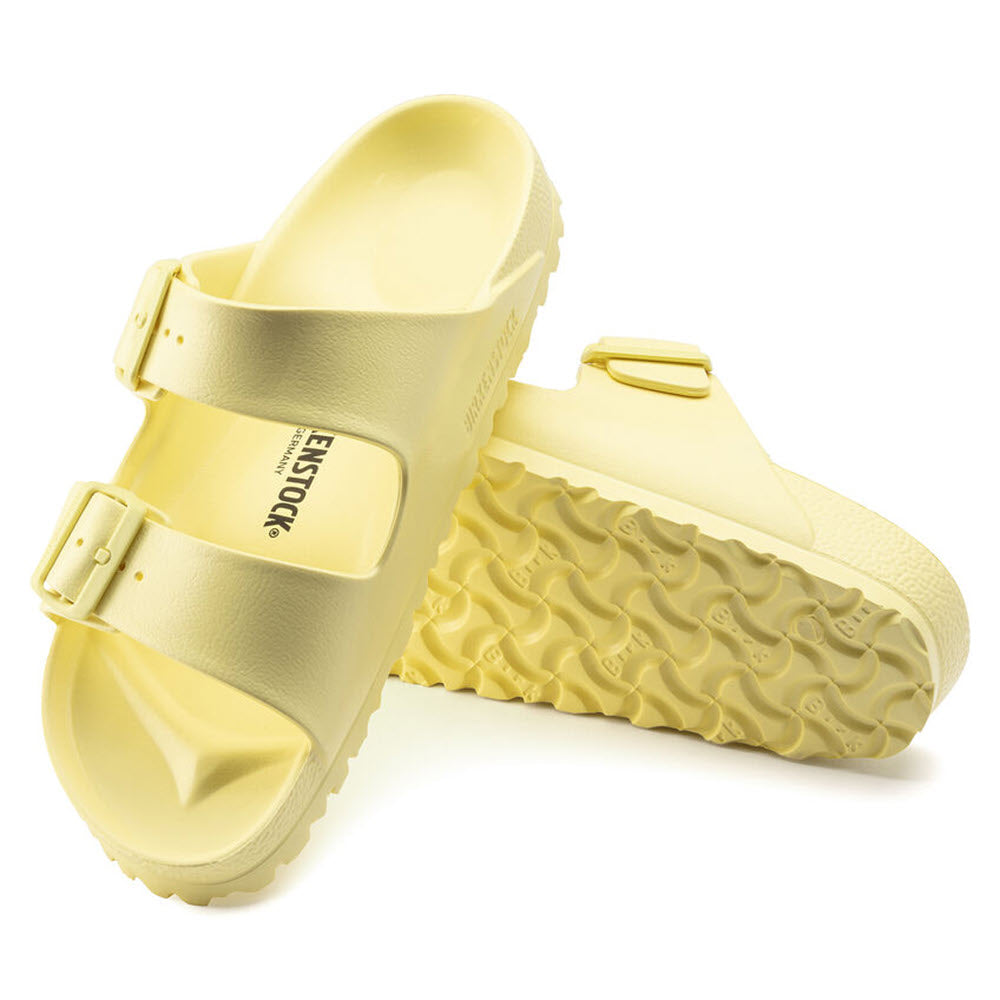 A pair of yellow Birkenstock ARIZONA EVA POPCORN sandals with buckle straps and textured soles on a white background.