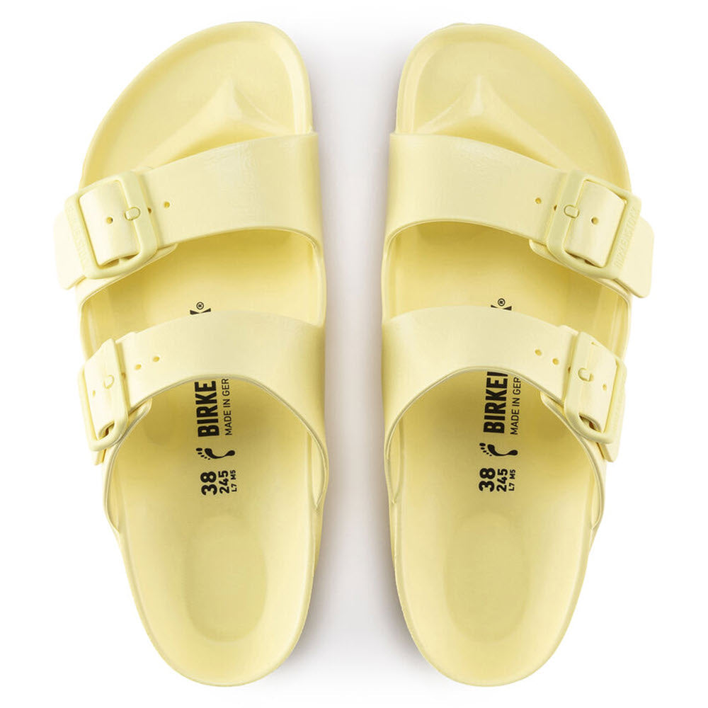 A pair of yellow Birkenstock Arizona Eva Popcorn sandals with buckles on a white background.