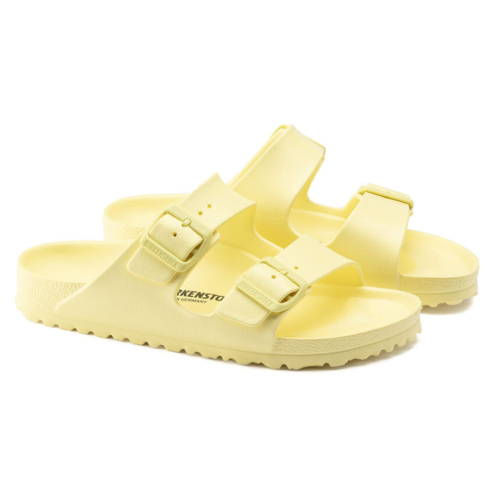 Pair of yellow Birkenstock Arizona EVA Popcorn sandals with adjustable straps on a white background.