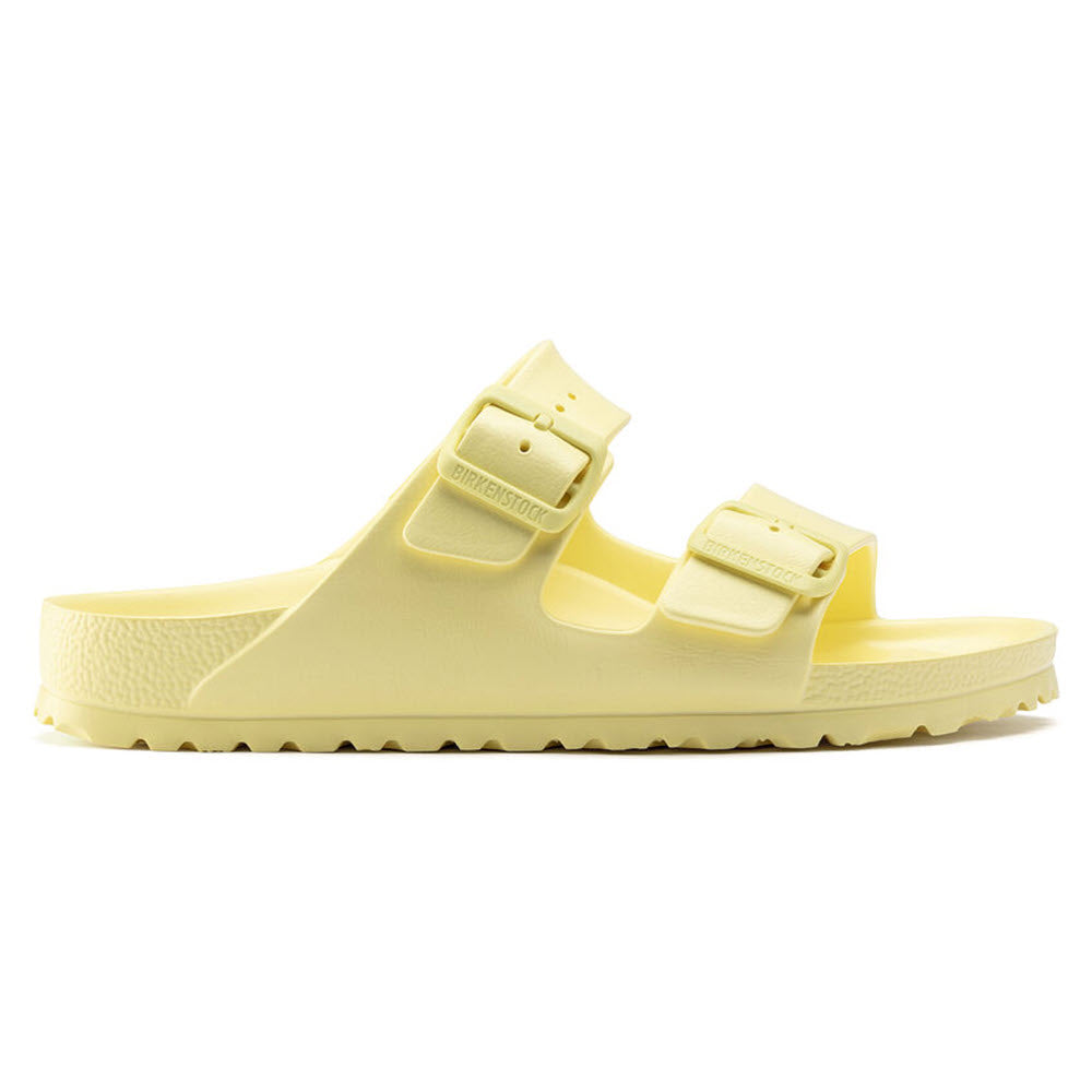 Yellow Birkenstock Arizona EVA Popcorn slide sandal with adjustable buckles on a white background.