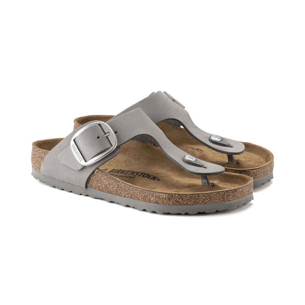 A pair of gray Birkenstock Gizeh Big Buckle sandals with buckles on a white background.