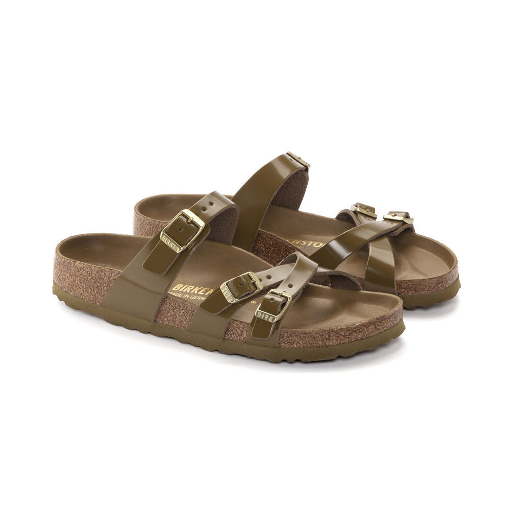 A pair of olive green sandals, featuring Birkenstock Franca Hex High Shine Mud Green design with buckle straps and cork-latex footbeds on a white background.