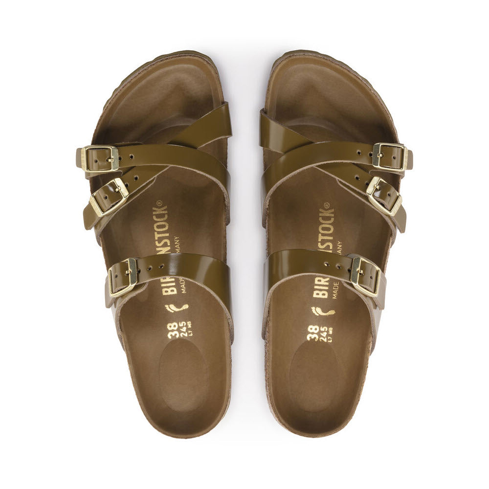A pair of natural leather Birkenstock Franca Hex High Shine Mud Green sandals with gold buckles, displayed from above with the brand name visible on the straps.