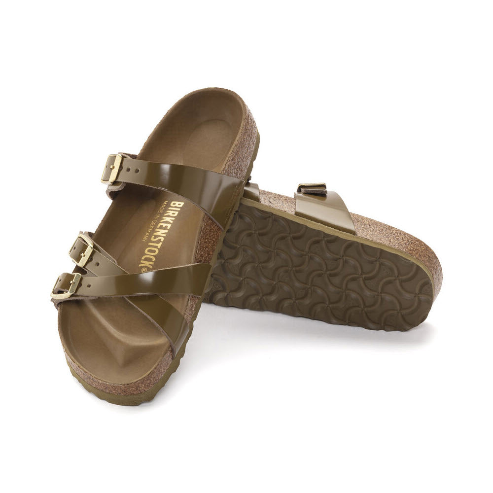 A pair of brown Birkenstock Franca sandals with adjustable straps and cork-latex footbed, isolated on a white background.