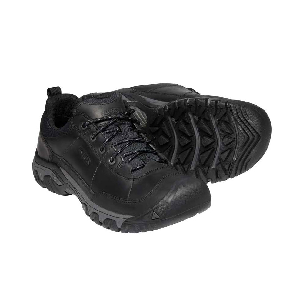 A pair of black Athletic Shoes with rugged soles and classic Keen Targhee traction, isolated on a white background.