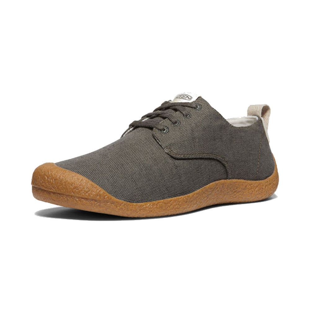 A single Keen Mosey Derby Canvas Black Olive - Mens shoe with a canvas blend upper and brown soles, displayed against a white background.
