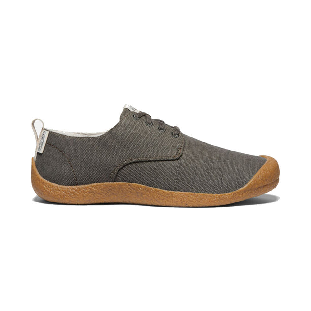 Side view of a Keen Mosey Derby Canvas Black Olive shoe with a brown rubber sole and laces, displayed against a white background.