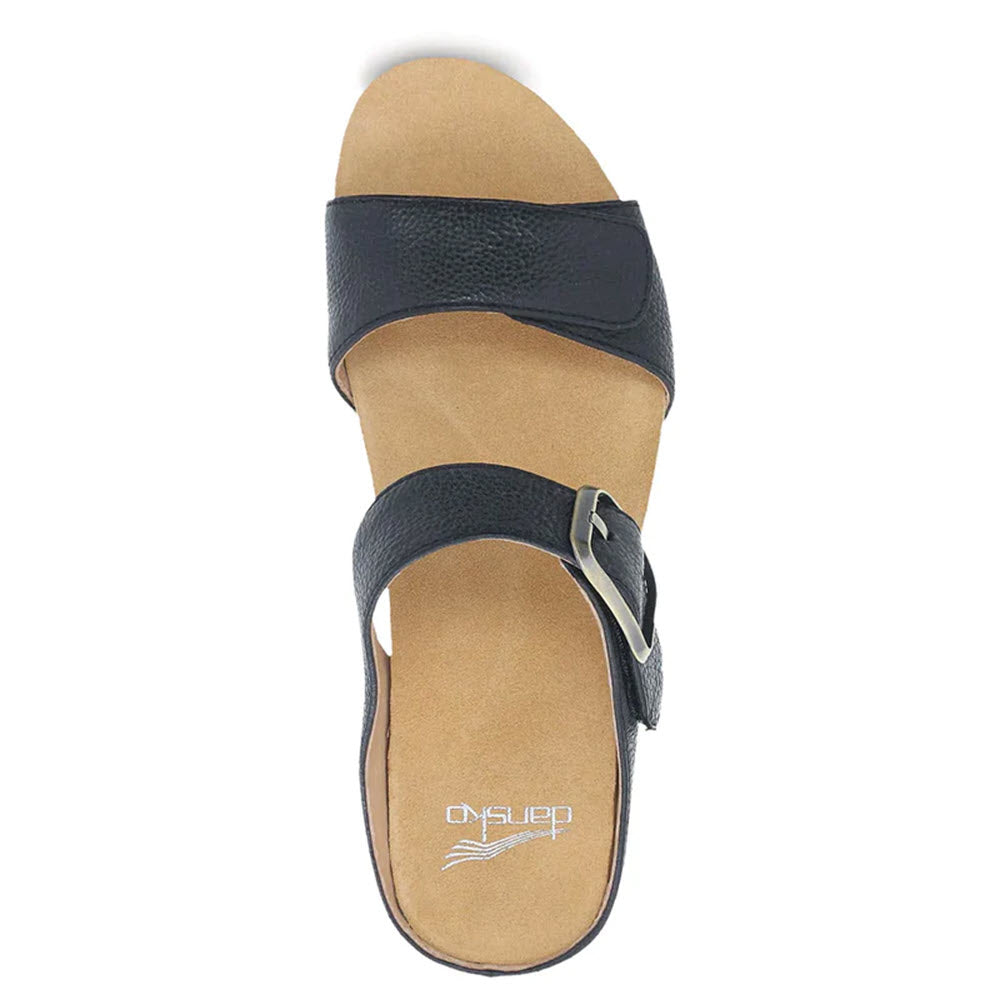 A single black Dansko Tanya Black - Womens Double Strap Slide Sandal with a broad strap and adjustable buckle, viewed from above on a white background.