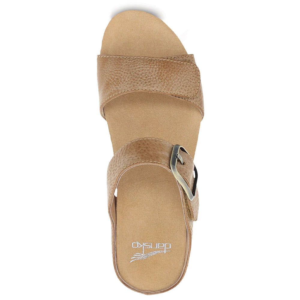 Top view of a beige, open-toe Dansko Tanya Tan Double Strap Slide Sandal with a buckle and textured straps.