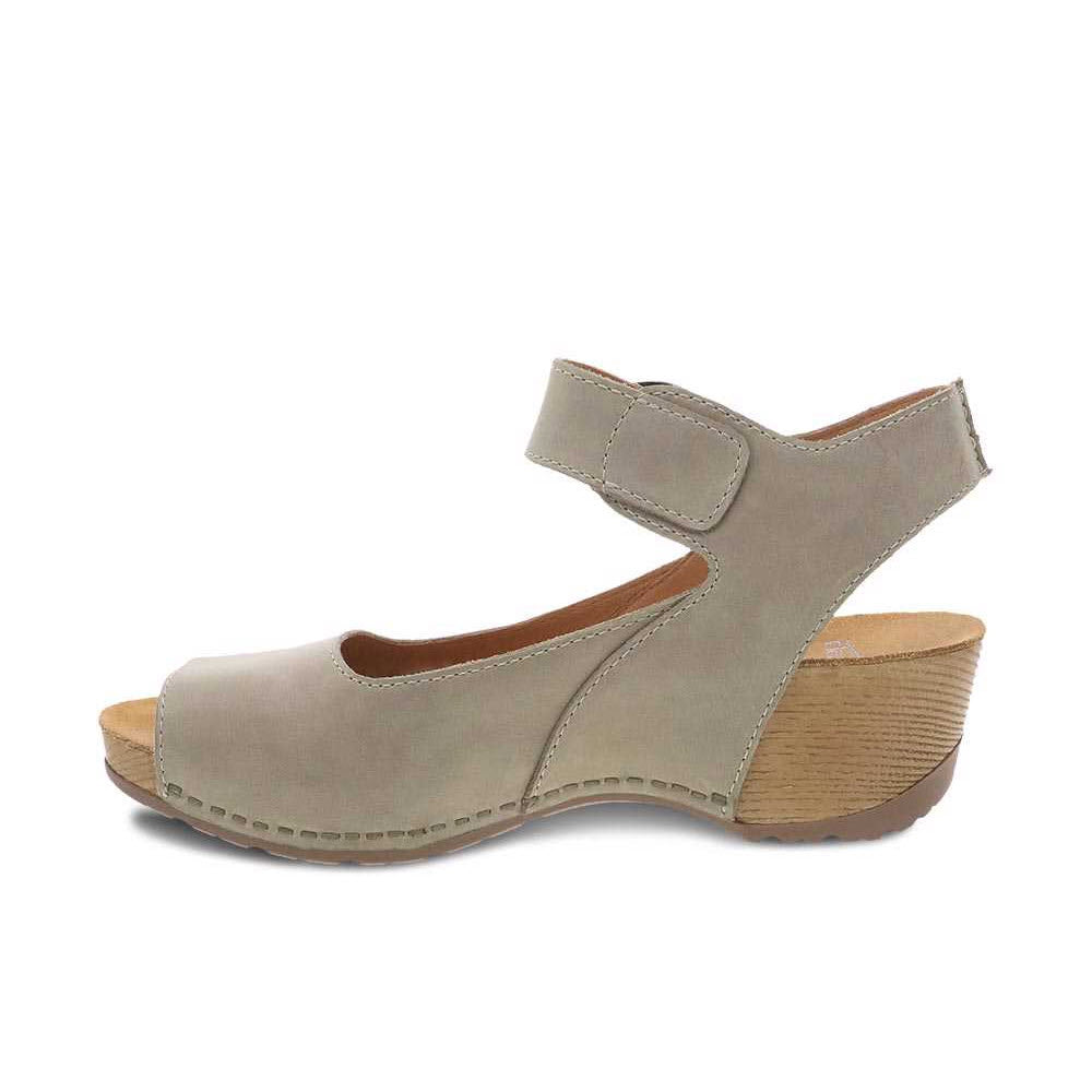 Beige Dansko Tiana Khaki Nubuck mary jane style shoe with an ankle strap and a wooden heel, isolated on a white background.