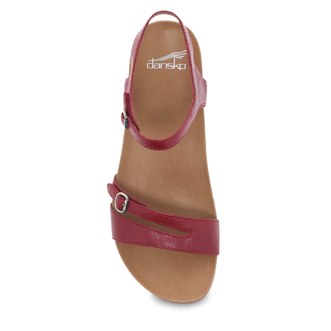 A red glazed leather Dansko Janelle sandal with an ankle strap and a brown insole, viewed from the side.