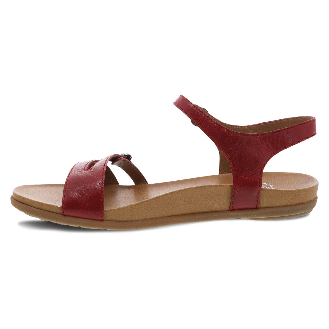 A single Dansko Janelle red glazed leather sandal with adjustable closures around the ankle and over the toes, displayed on a white background.