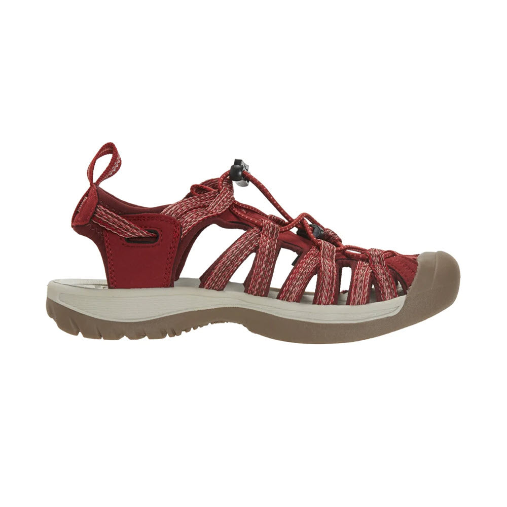 Side view of a Keen Whisper Red Dahlia - Women&#39;s strappy sandal with a beige sole and a drawstring closure on a white background.