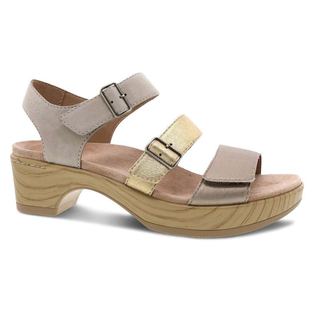 A beige, triple strap Dansko Malena Metallic Multi sandal with buckle closures and a chunky wooden heel on a white background.