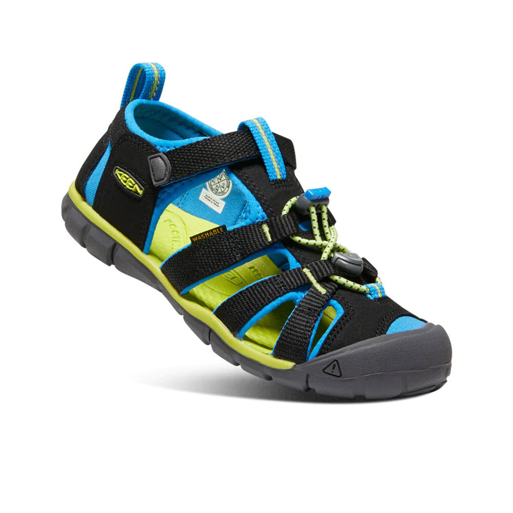 A Keen® Kids Seacamp II CNX sandal with black and blue straps, featuring adjustable drawstring closure and a black rubber sole.