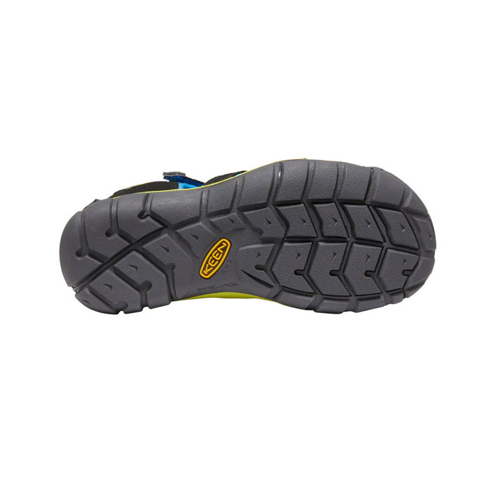 Bottom view of a Keen® Kids Seacamp II CNX outdoor shoe with a gray treaded sole and a yellow logo.