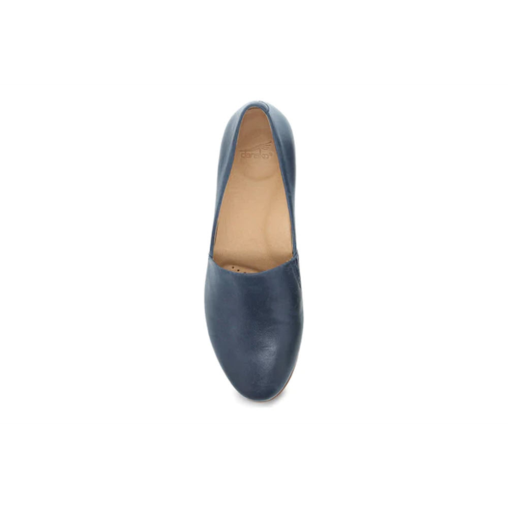 Top view of a single navy blue Dansko Larisa slip-on flat with arch support technology on a white background.
