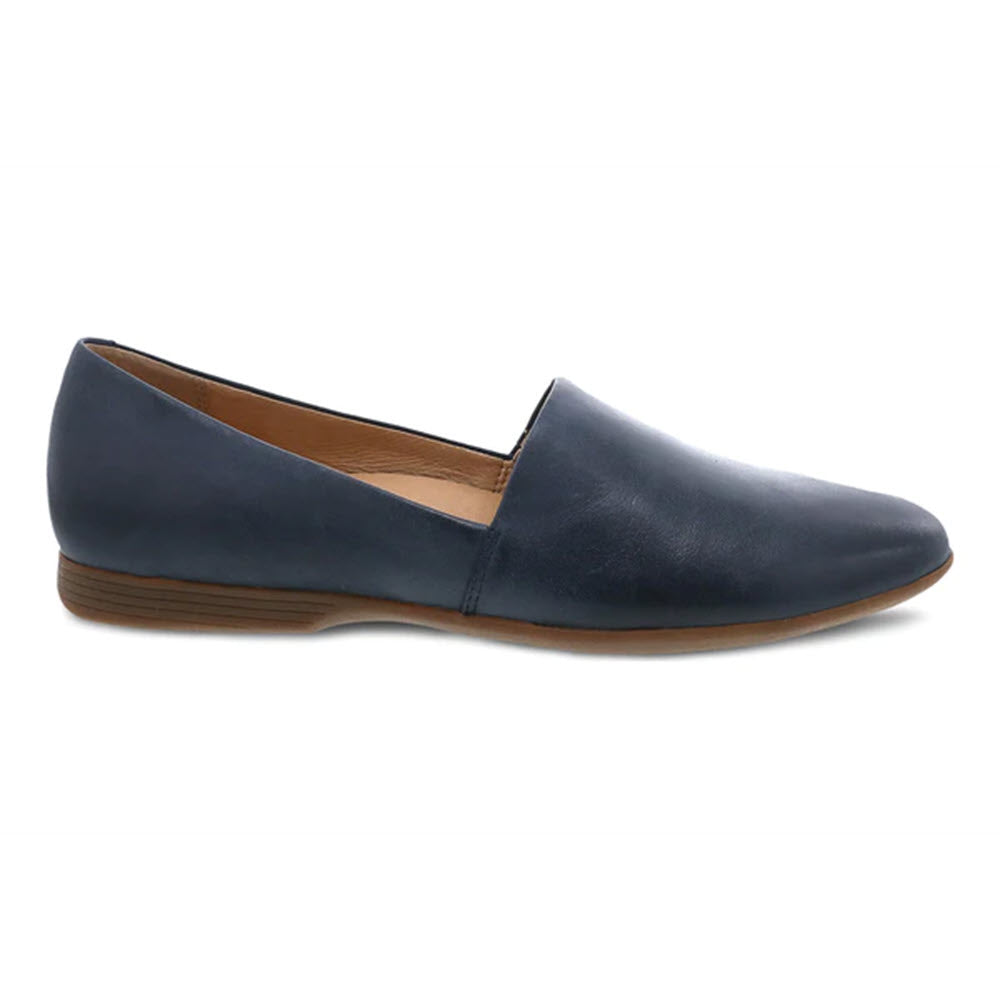 A single navy blue Dansko Larisa slip-on flat with leather uppers, a pointed toe, and minimal heel, displayed against a white background.