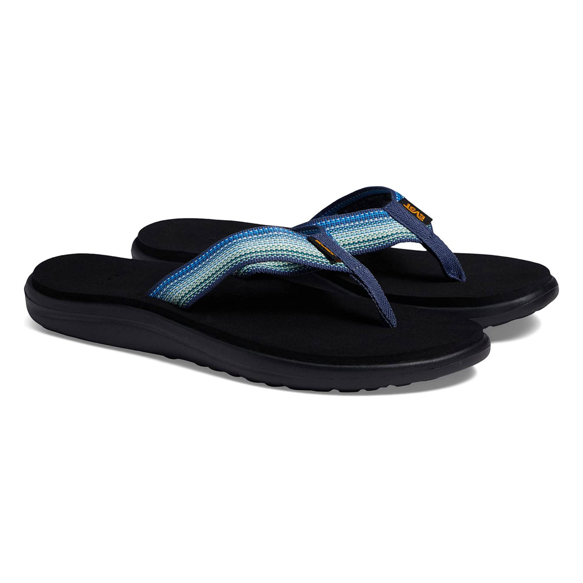 A pair of Teva Voya Flip Antigous Navy Multi sandals with black soles and blue straps, featuring a small orange logo on each strap, displayed against a white background.