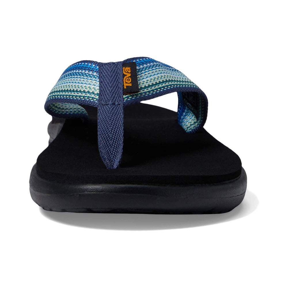 A single blue and green patterned Teva Voya Flip Antigous Navy Multi sandal with a black sole on a white background.