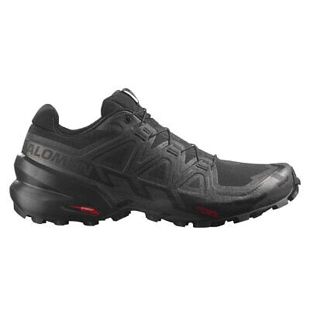 Black Salomon Speedcross 6 trail running shoes with prominent brand logo on the side, featuring a rugged sole designed for mud evacuation and red detailing.