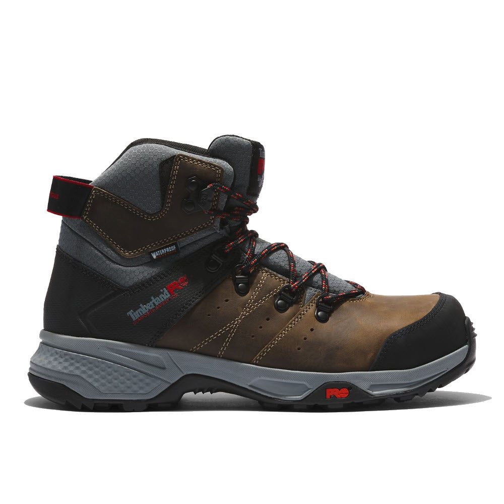 A Timberland CT Switchback Waterproof Turkish Coffee men&#39;s work boot in brown and black with red accents, a gray sole, and a composite safety toe.