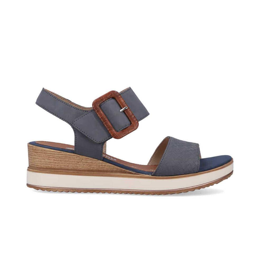 A Remonte denim blue sandal with a large buckle, featuring a chunky wooden heel and ridged sole, isolated on a white background.