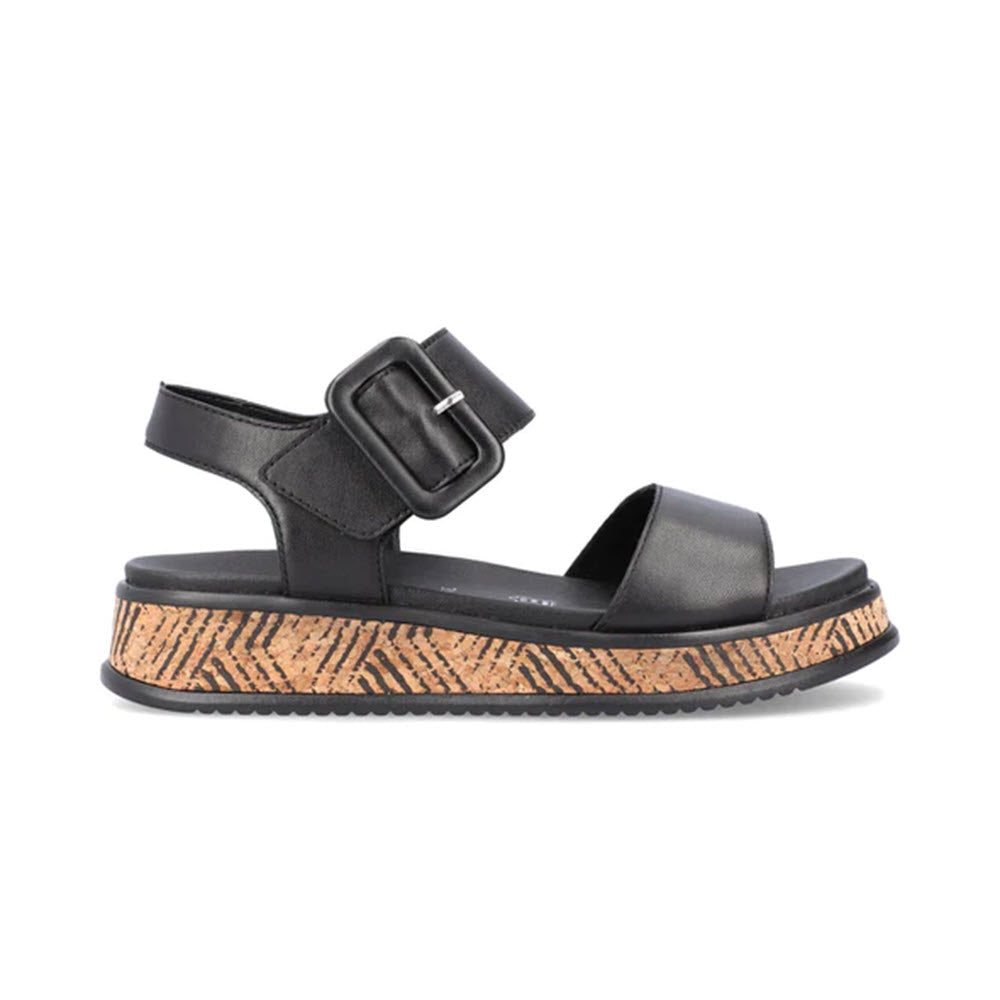 Black Revolution sandal with cork-style sole and velcro straps, isolated on a white background.