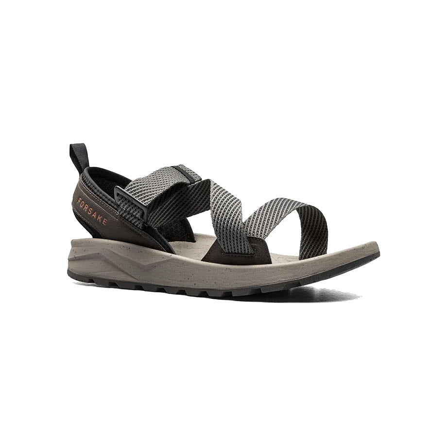 A single Forsake Rogue Loden - Mens adventure sandal with black and white straps on a white background.