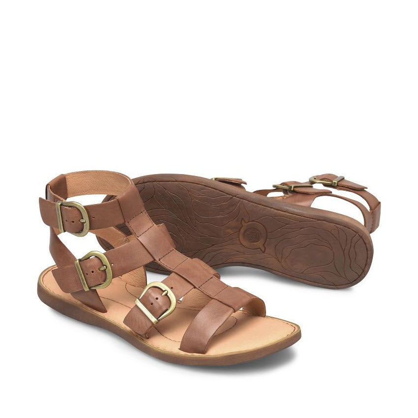 A pair of Born Haidee brown, soft leather gladiator sandals against a white background.