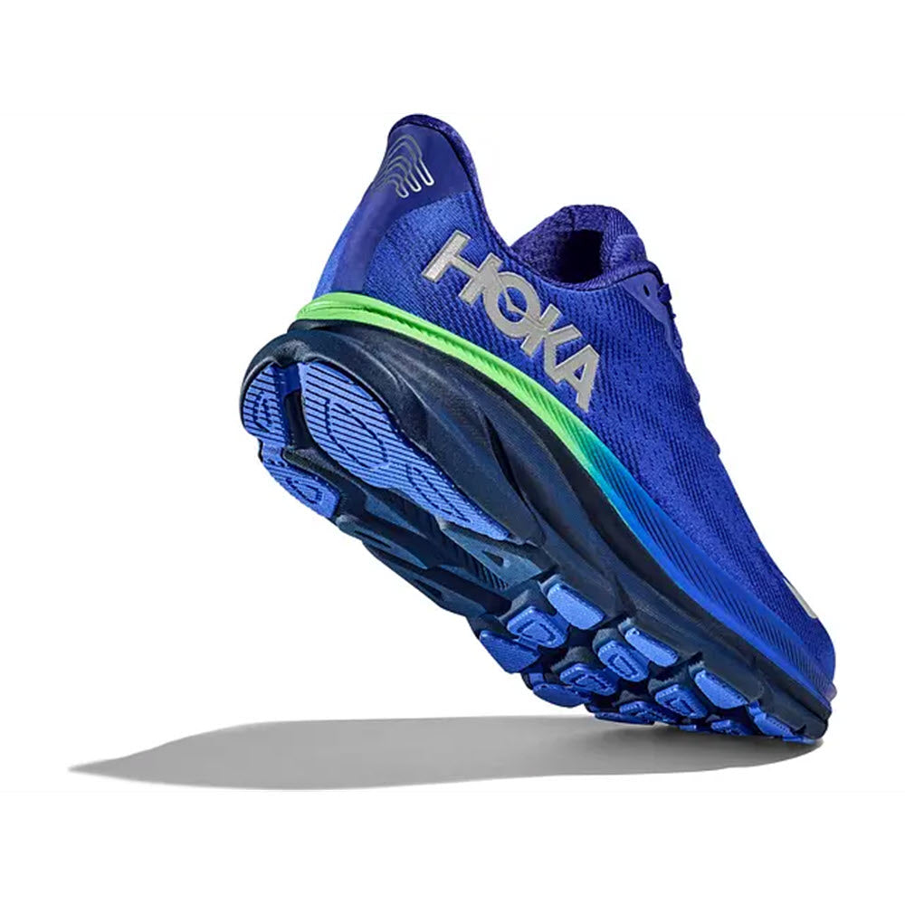 Blue Hoka Clifton 9 GTX running shoe with neon green accents, and enhanced grip soles floating against a white background.
